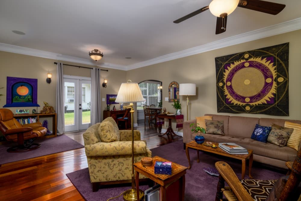 Family room with French doors, arch to the dining room and large wall art, Rock Hill, SC